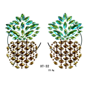Detailed view of XT-32 pineapple rhinestone breast stickers in green and brown gems