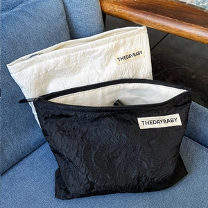 Detail of black and white rose jacquard texture on large capacity canvas toiletry bags
