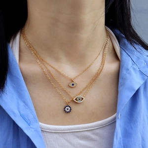 Three-layer gold evil eye pendant necklace with blue and white cubic zirconia accents