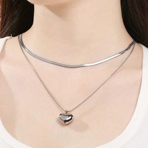 Close-up of double-layer stainless steel heart necklace on model's neckline