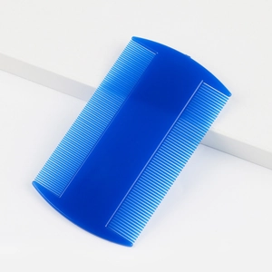 Close-up of double-sided fine-tooth pet flea comb in navy blue plastic for grooming