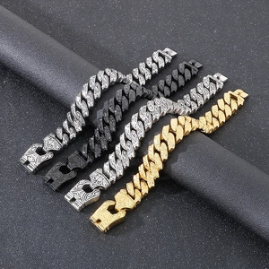 Macro detail of retro engraved Cuban chain bracelets in gold, silver and gun black finishes