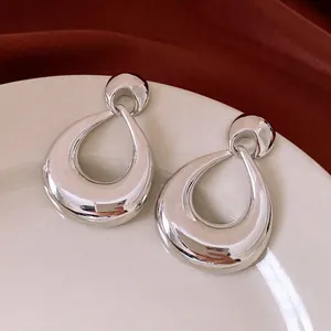 Polished silver teardrop earrings in a minimalist geometric design for high-fashion style