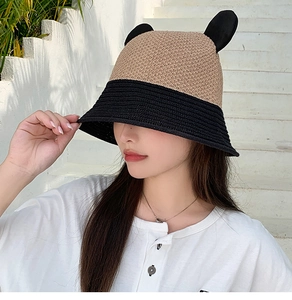 Detail of cute bear ears on a khaki and black woven bucket hat for women outdoors