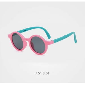 Detail view of foldable pink and teal kids' round sunglasses at a 45-degree angle