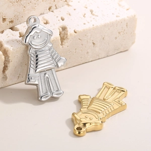 Gold and silver cartoon boy charms in stainless steel displayed on a natural stone base