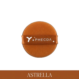 Macro detail of round caramel air cushion puff with branded satin ribbon strap