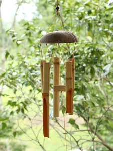 Detail of natural bamboo wind chime with coconut shell top and six hanging tubes