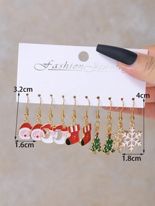 Detail view of colorful Christmas earring set showing Santa and snowflake charms on card