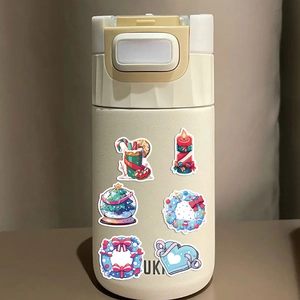 Creamy insulated bottle decorated with cute Christmas cartoon stickers and festive patterns