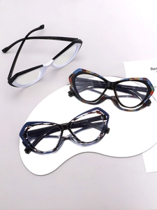 Detailed close-up of cat-eye eyewear frames in black-white, blue, and amber textures