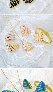 Detailed close-up of geometric triangle jewelry set featuring zebra patterns and enamel finish
