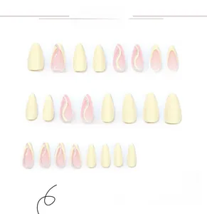 Detail of yellow and pink press-on nails with glitter wave lines in almond shape