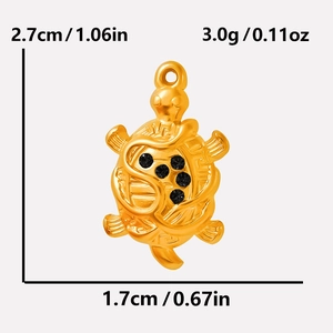 Macro view of 18k gold turtle pendant showing size 2.7x1.7cm and black crystal details