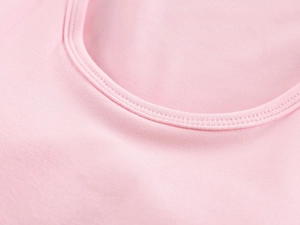 Detailed close-up of the fine stitching on a pink knitted ribbed crew neck sports vest