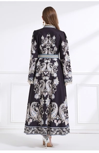 Detailed back view of vintage paisley print maxi dress with lace cuffs and silken texture