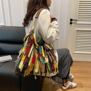 Bohemian snakeskin textured crossbody bag with multi-color fringe and striped design