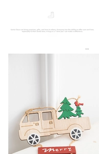 Detail of wooden Christmas truck ornament featuring Merry text and mini green pine trees
