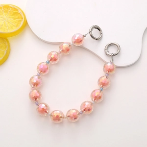 Detail view of colorful acrylic beads and silver spring rings for mobile chain