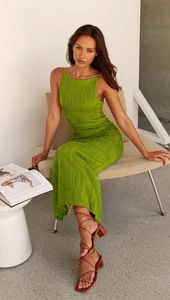 Close-up of green pleated fabric texture on a slim-fit backless sleeveless maxi dress