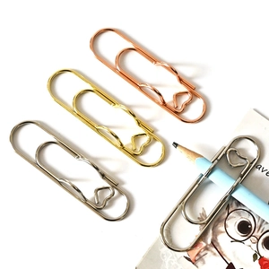 Heart-shaped metal pen clips in rose gold, gold, and silver for planners and notebooks