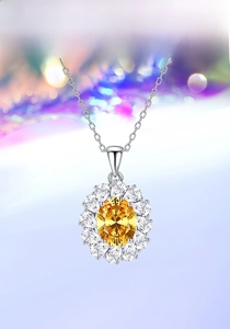 Macro view of oval yellow gemstone pendant with diamond halo on silver chain necklace