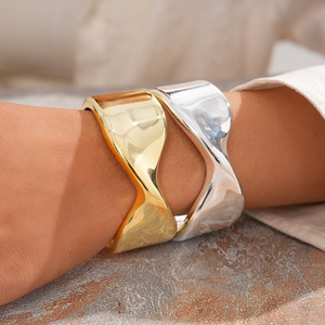 Minimalist wide wave cuff bracelet in gold and silver finish with geometric twisted design
