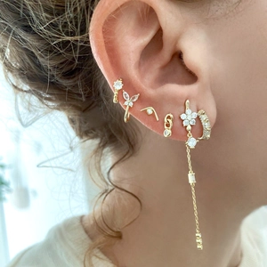 Gold star stud earrings with long zircon tassels and chain set worn on ear