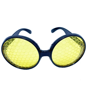 Detail of yellow round party glasses featuring a black hexagonal honeycomb lens pattern