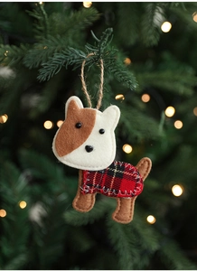 Detail of handmade felt puppy ornament with red plaid cloth on a festive Christmas tree