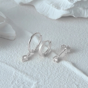 Detailed view of S925 sterling silver evil eye earrings set including studs and hoops