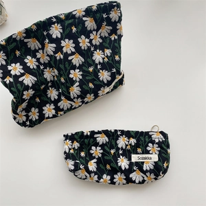 Floral daisy embroidery cosmetic bag set in black canvas with secure zipper closure