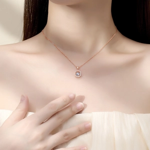 Elegant rose gold square pendant necklace with moissanite dancing stone on model's neck