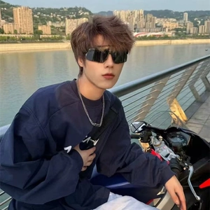 Outdoor lifestyle shot of cycling photochromic sunglasses with black oversized lenses
