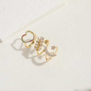 Three-piece gold 14K plated ring set featuring heart, leaf, and moon star zircon designs