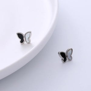 Minimalist titanium steel butterfly stud earrings with black and white enamel finish