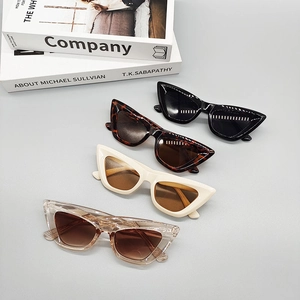 Detail of retro cat-eye sunglasses in black, tortoiseshell, cream, and tawny colors