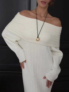 Detail of white off-shoulder knitted dress showing vertical ribbed texture and fold-over neckline