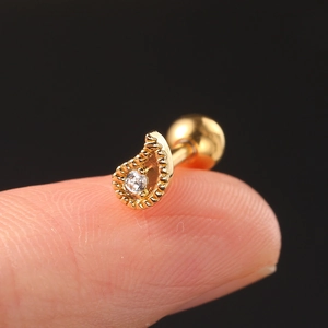 Golden marquise zircon helix piercing stud shown on fingertip for size reference