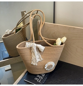 Close-up of large woven tote bag with lace bow and daisy floral decoration