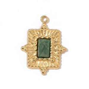 Detailed view of a vintage gold pendant with square green stone and sunburst pattern
