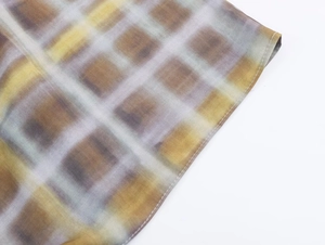 Gros plan détaillé du tissu écossais jaune et violet avec couture à bord roulé