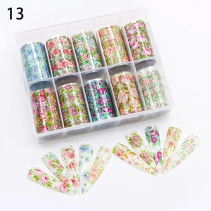 Detailed set of 10 floral nail art transfer stickers in a transparent plastic storage box