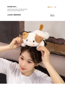 Close-up of a cute plush cat hair accessory with soft white fur and brown ears on a model