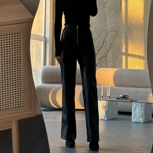 High waist black faux leather wide leg trousers with split hem and zipper waist detail