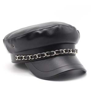 Detailed close-up of a black PU leather flat-top hat with a silver metal chain accessory
