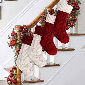 Close-up of knit Christmas stockings in red and white with classic cable pattern textures