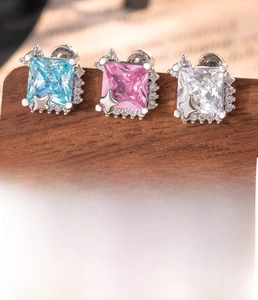 Macro shot of square-cut zircon studs in blue, pink, and white with 0.8x6mm screw bars