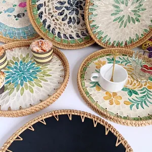 Handcrafted rattan serving trays with colorful shell inlay and diverse floral patterns