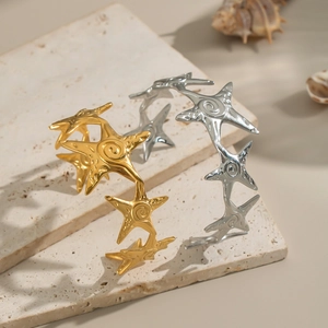Starfish open bangles with spiral texture in gold and silver finish on a stone